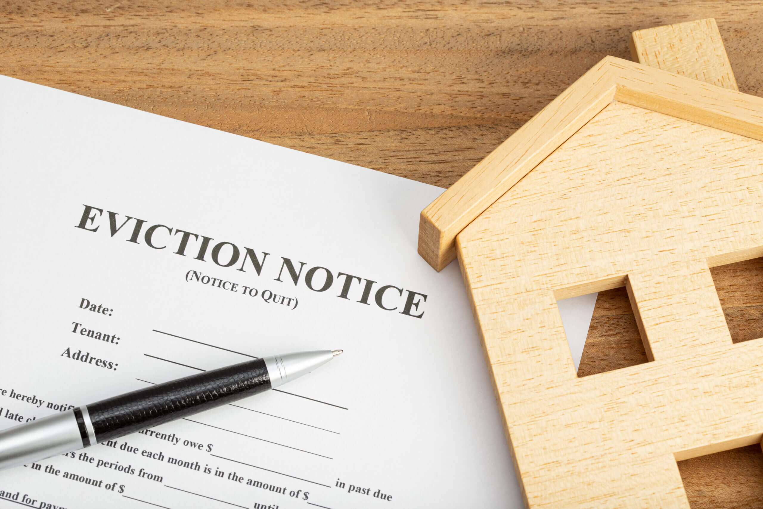 Eviction Notice / Notice to Quit document with a wooden house model