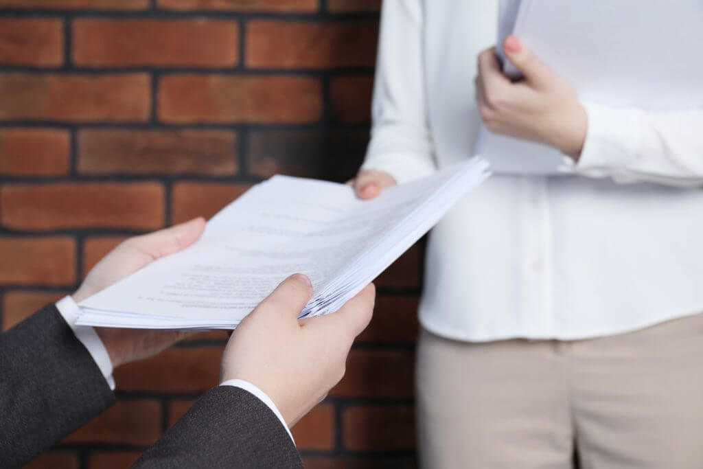 Process server handing over legal documents
